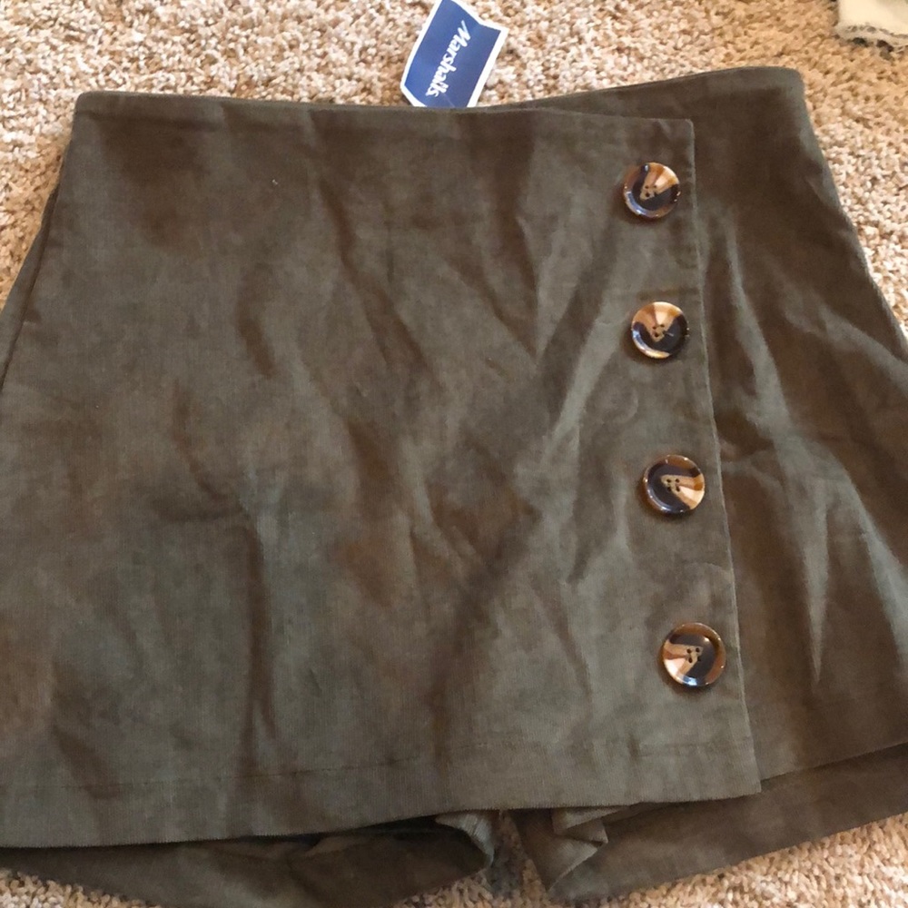 green skort with turtle shell buttons